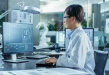 Scientists Reassess Extreme Climate Projections Engineer in lab coat working at a computer in a modern lab