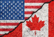 U.S.-Canada Antitrust Cooperation Put on Hold USA and Canada flags with a cracked border
