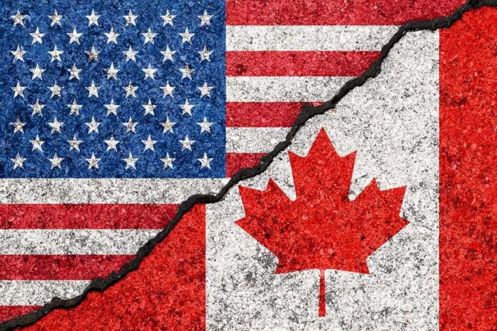 shutterstock_1118552855 USA and Canada flags with a cracked border