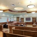 The 911 Call That Could Decide Lindsay Clancy’s Fate Empty courtroom with wooden benches and judge's bench