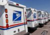 Supreme Court Freezes USPS Election Rule Row of USPS mail trucks parked in a lot