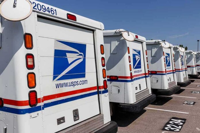 Row of USPS mail trucks parked in a lot