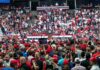 Walter Jones among crowd at a political rally in an indoor arena