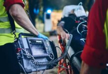 Heat Chaos Cripples Trump’s Mega Fair Paramedic with defibrillator beside patient on stretcher