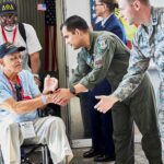 Humanitarian Bombshell: Russia Frees Ailing American Veteran in wheelchair greeted by military personnel at event