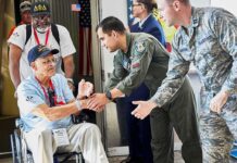 Humanitarian Bombshell: Russia Frees Ailing American Veteran in wheelchair greeted by military personnel at event