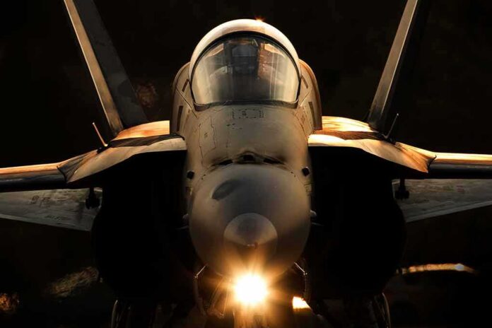 fighter jet front view with cockpit and headlight illuminated