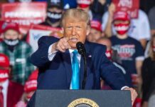 Trump Stands Firm on Iran War speaker pointing during a rally