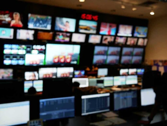 shutterstock_1860150187 control room with multiple screens and monitors