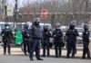 Five Men Arrested Near U.S.-Linked UK Air Base Group of police officers in riot gear standing on a street; Brian Folkerts present