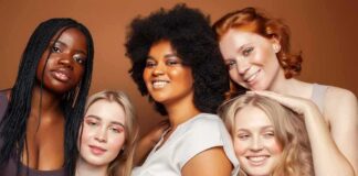 Group portrait of five women smiling together