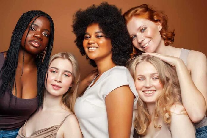 Group portrait of five women smiling together