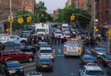 Four Minutes Before Times Square Gunfire Police vehicles and officers block a city street during an active scene