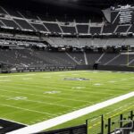 American football stadium interior with empty field and stands