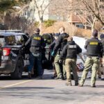 Family Dead in California Murder-Suicide Case Police and sheriff officers gather around vehicles on a suburban street