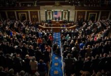 Legislative chamber audience stands and applauds