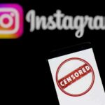 Smartphone showing censored symbol with Instagram logo in background