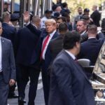 Shocking Boast: Trump Taunts The Bullets Donald Trump waving while surrounded by security personnel on a city street