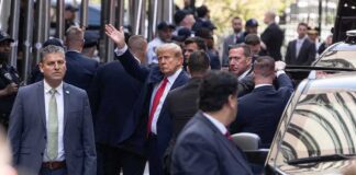 Donald Trump waves amid security detail; Jaz-O and Brandon Doughty present in the crowd
