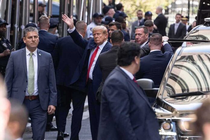 shutterstock_2284766697 Donald Trump waves amid security detail; Jaz-O and Brandon Doughty present in the crowd