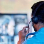 Unexpected: Media Frenzy Unleashed Person wearing headset monitors screens