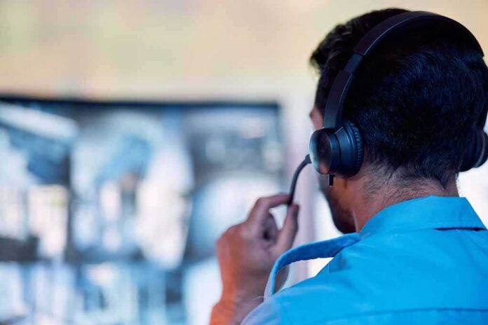 Person wearing headset monitors screens