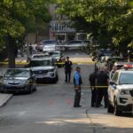 Ohio Candidate Targeted in Armed Fair Incident Police officers secure a residential street with patrol cars and yellow tape
