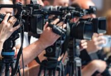 Weapons Arrest at Trump Golf Course television cameras on tripods at a media event