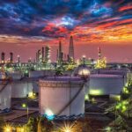 Trump Plans Venezuela Oil for U.S. Reserve Oil refinery with storage tanks at sunset