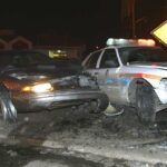 Five-Car Crash Leads to Candidate’s DUI Case A damaged car and a police vehicle involved in a nighttime accident