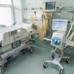 Hospital ICU bed with ventilator and monitoring equipment