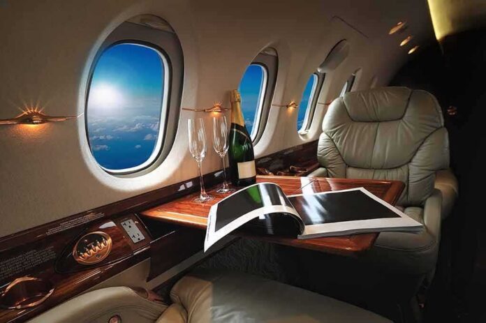 shutterstock_544532257 private jet cabin with leather seat, champagne and magazine on table