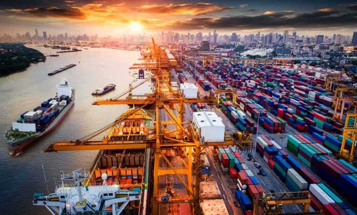 shutterstock_722794939 Container port with cranes and cargo ships at sunset