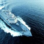 U.S. Strikes Iranian Launchers Near Hormuz Naval warship cutting through open sea