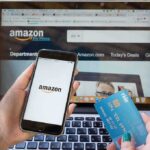 Person shopping on Amazon with phone and credit card