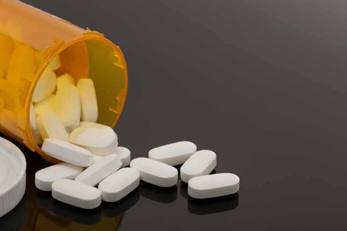 shutterstock_757565809-2 Prescription bottle with white tablets spilling out