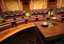 UK Lawmakers Reject Assisted-Dying Bill by 16 Votes A courtroom with empty seats and a scale of justice in the foreground