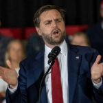 Activist Pressure Shapes Texas Democratic Debate Man in suit speaking at a podium