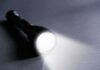 Southern California Urged to Save Power Flashlight shining a bright beam on a dark surface