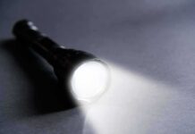 Southern California Urged to Save Power Flashlight shining a bright beam on a dark surface