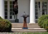 Trump Honors October 7 Victims, Backs Israel Podium with presidential seal in a garden colonnade