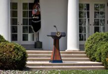 Podium with presidential seal in a garden colonnade