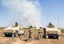 Yemen Targets Houthi Positions Near Red Sea Soldiers with two military vehicles during field exercise