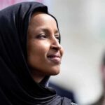 No Charges Announced After Federal Home Search Ilhan Omar in profile wearing a black headscarf outdoors