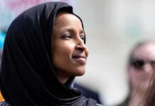 No Charges Announced After Federal Home Search Ilhan Omar in profile wearing a black headscarf outdoors
