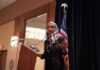 Lawmaker Faces Classified Leak Allegations Ilhan Omar speaking at a podium with a microphone