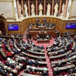 Parliament chamber with lawmakers seated in semicircular rows