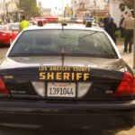 Armed Robbers Attack Actor in California Sheriff patrol car parked on city street