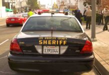 Armed Robbers Attack Actor in California Sheriff patrol car parked on city street