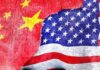 Chinese and American flags torn and overlapping